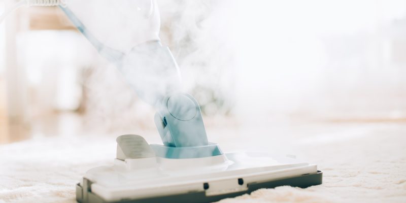 Cleaning the floor with steam cleaner. Banner and copy space. Cleaning service concept